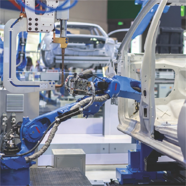 Robotic arm operating in an automated manufacturing facility.